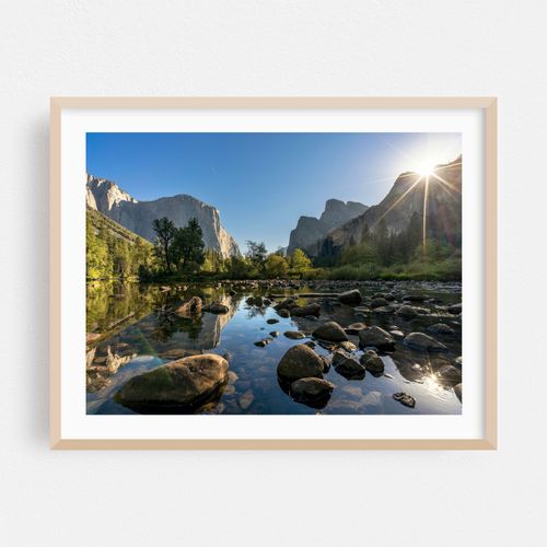 Sunlight dances on the water, highlighting granite cliffs