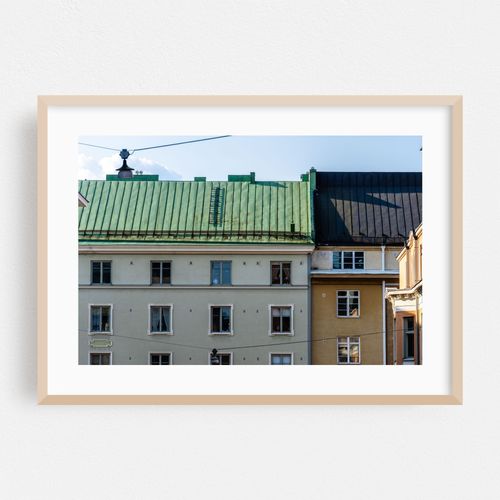 The colorful roofs and facades of Helsinki buildings shine on a bright day in Finland.